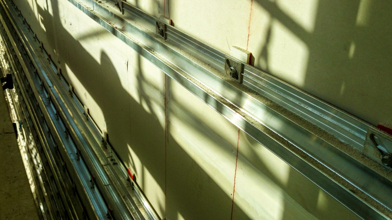 Aluminum rail system installed on the wall before the stone