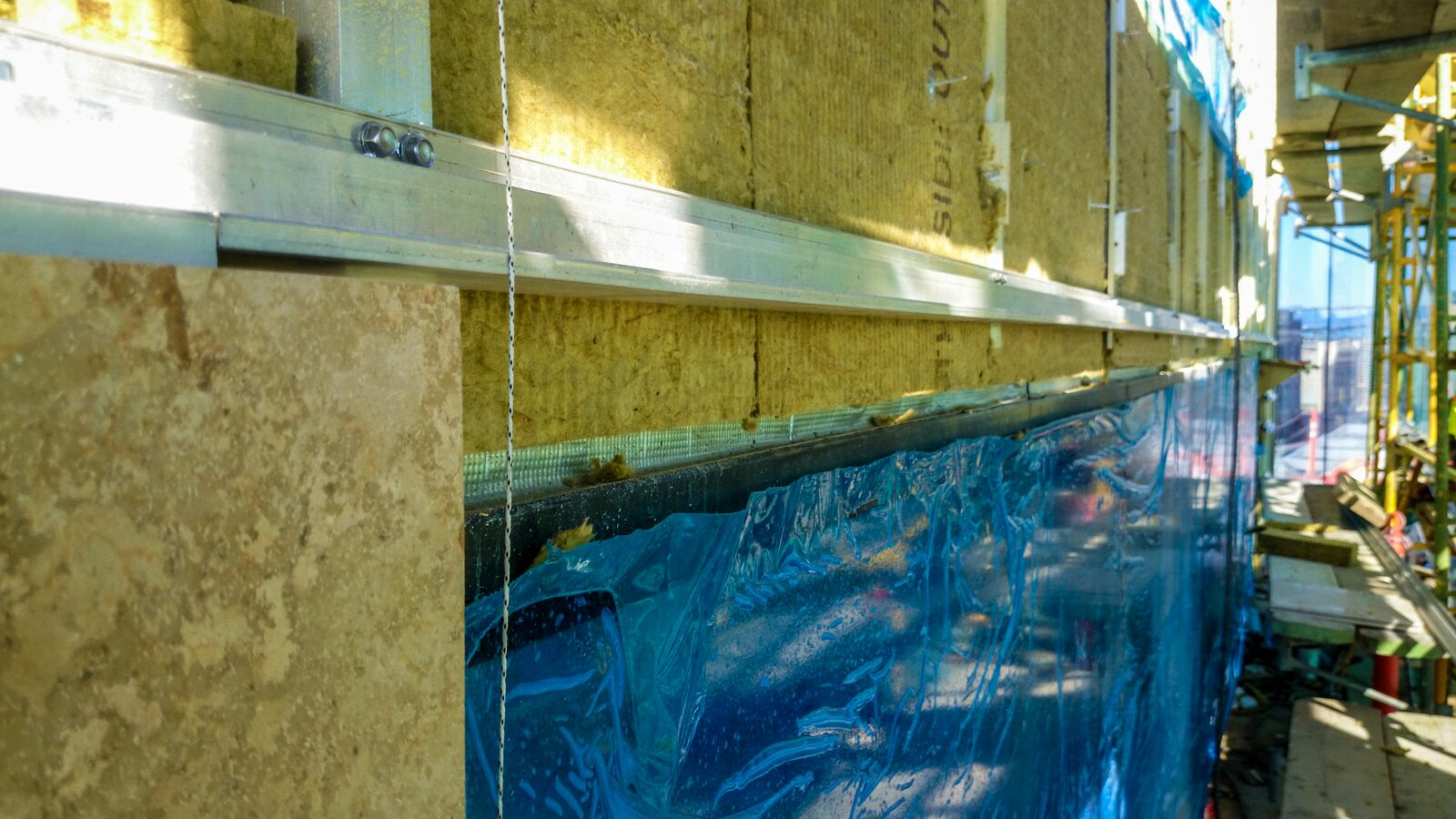 Rails over insulation and air barrier on the Anvil facade