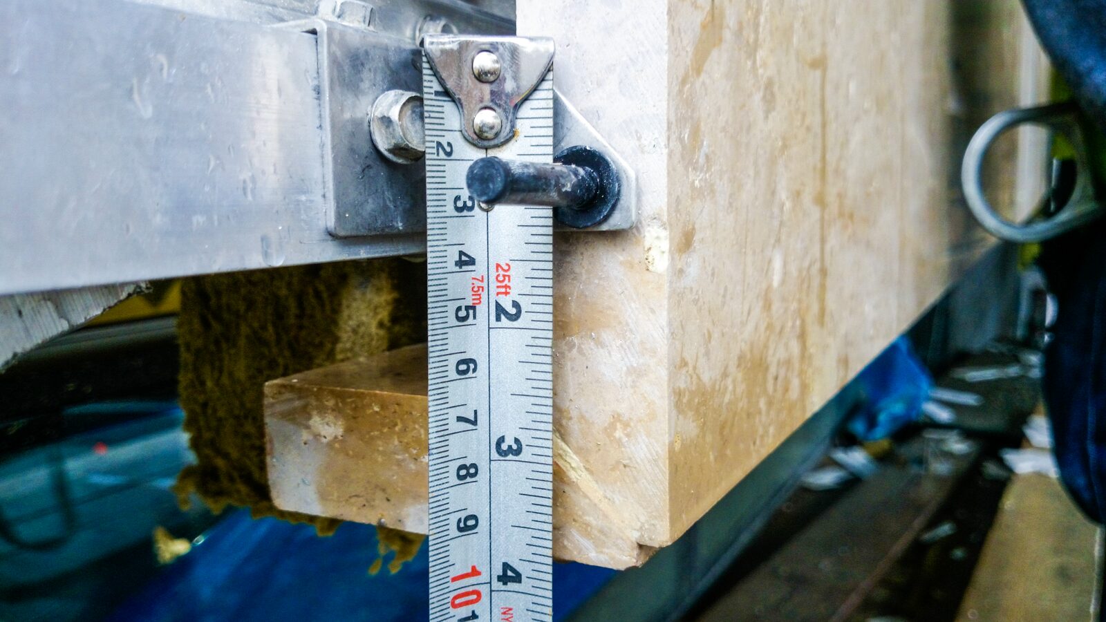 Measuring a limestone panel edge during installation